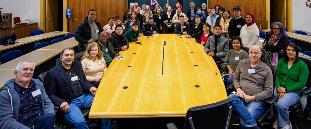 Photo of a group of people around the Council Chamber table