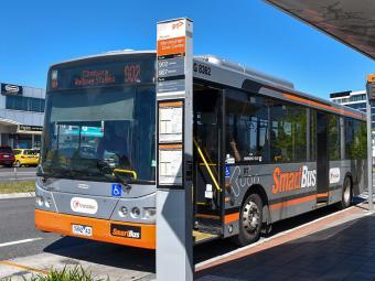 Photo of the front of a bus at a bus stop